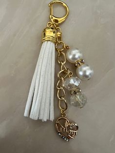 a tasseled keychain with an elephant charm and pearls on the end