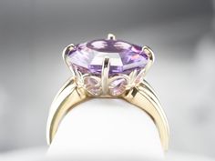 Outstanding! This solitaire cocktail ring is all about the gemstone. One, simple, solitary gem, set up in the modernist style. The clean geometric lines of this fancy cut allow this wonderful amethyst to sparkle with undertones of regal purple and raspberry, we've set this stone into a simple two-tone gold mounting creating a sophisticated statement piece! Metal: 14K Yellow and White Gold Gem: Amethyst 4.20 Carats Gem Measurements: 13.0 mm, Octagon Ring Size: 6.50 Marks: "IJS14K" Stamped on the Octagon Ring, Amethyst Cocktail Ring, Gold Amethyst Ring, Purple Band, Birthstone Gifts, February Birthstone, Geometric Lines, February Birth Stone, Metal Pendant