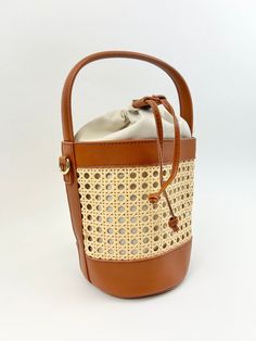 We love a bucket bag to carry all our essentials, and this woven rattan bag is the perfect bag to carry around all summer long! Product Details Material: Vegan Leather & Rattan Size: 11"L x 9"W Handle and Crossbody Strap Features a drawstring closure Natural Color Pouch Bucket Bag For Travel, Summer Pouch Bucket Bag With Adjustable Strap, Daily Use Basket Bucket Bag With Leather Handles, Daily Use Straw Pouch Bag, Everyday Woven Leather Straw Bag In Bucket Shape, Summer Straw Crossbody Bucket Bag, Rectangular Straw Bucket Bag With Adjustable Strap, Beach Straw Pouch Bag With Leather Handles, Casual Bucket Bag With Bamboo Handle For Daily Use