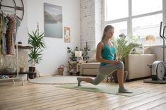 a woman is doing yoga in her living room