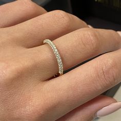 a woman's hand with a diamond ring on it