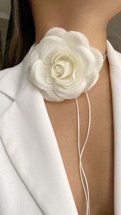 a woman wearing a white flower necklace