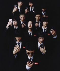 a group of young men in suits and ties holding cell phones