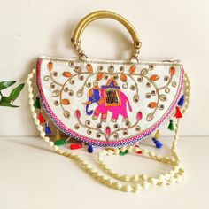 Cotton Traditional Ethnic Rajasthani Jaipuri Embroidered Elephant Handbag | Sling Bag for Girls/Women | Indian Sling Bag | Ethnic Purse. This stylish Shoulder Bag Makes your appearance a more elegant. Good Quality Double Handle Well Finished Thread Work. Ideal for women and girls, specially designed to carry in parties and weddings. Carry this Rajasthani Jaipuri handbag with any traditional or casual attire. It will complete and Enhance your look perfectly. Great addition to your collection. Siz Bohemian Multicolor Potli Bag For Diwali, White Rectangular Shoulder Bag For Festive Occasions, Multicolor Shoulder Bag With Dori Work For Festivals, Festive Bohemian Bag With Dori Work, Traditional Handheld Bag With Multicolor Embroidery, Traditional Multicolor Embroidered Handheld Bag, Festive Bohemian Bags With Dori Work, Festive Multicolor Shoulder Bag With Dori Work, Bohemian Embroidered Potli Bag For Diwali