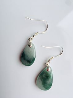 A pair of real green&white jade teardrop earrings with 925 Sterling Silver hook. The simple and delicate teardrop earrins are carved from Grade-A quality green icy jade. The jade color is all-natural and genuine, clear jade texture can be easily observed under the daylight. Some highlights of this pair of minimalistic jade earrings: *High quality guaranteed. Grade-A natural green jade, handmade with 925 sterling silver. *Graceful and simple teardrop design *Each teardrop is measured around 1 Hypoallergenic Jade Drop Earrings, Hypoallergenic Green Teardrop Jewelry, Nickel-free Teardrop Jade Jewelry, Nickel-free Green Drop Jewelry, Green Nickel-free Drop Jewelry, Handmade Jade Drop Earrings, Handmade Jade Drop Earrings Jewelry, Handmade Green Teardrop Earrings, Green Teardrop Drop Earrings For Jewelry Making