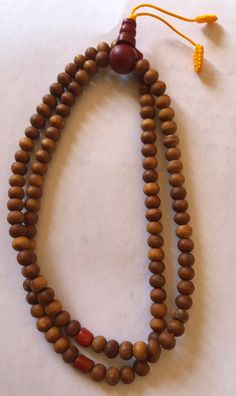 This small sandal wood mala has three traditional decoration beads and guru beads. It is from Nepal and nice and beautiful mala. it is 11 inches long mala. Holistic Healing Mala With Wooden Beads, Traditional Wooden Beads Necklace For Healing, Holistic Wooden Beads Mala For Rituals, Handmade Wooden Beaded Bracelets For Meditation, Holistic Brown Mala With Wooden Beads, Holistic Wooden Mala For Rituals, Brown Wooden Beads Spiritual Mala, Hand-strung Brown Mala For Healing, Traditional Wooden Beaded Bracelets