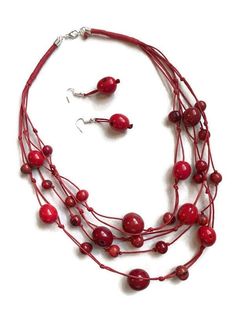 Red Tagua Bib Necklace Ecuadorean Tagua Jewelry - Eco Friendly Part Number: TAG707 Item Weight: 1.15oz Product Length: 24 inches long Earrings Length: 2 inches About Tagua This Product is handcrafted from a palm tree nut native to the lush tropical rainforests of Ecuador. Also referred to as the Ecuadorean Ivory Palm, the Tagua tree produces several bushels of seed pods a year with up to 100 Tagua nuts per pod. These nuts are then harvested, dried, and crafted into a wide range of products from Eco Friendly Necklace, Tagua Necklace, Tagua Jewelry, Tagua Nuts, Tropical Rainforest, Seed Pods, Diy Stuff, Bib Necklace, Necklace And Earrings