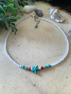 Beach motive choker made a turquoise howlite starfish accented with , white glass pearl, and turquoise and red Czech glass rondelles. In between has small stainless steel beads and finished with white pearlescent Czech glass seed beads and stainless steel lobster clasp and extender chain Measurement is 15inches plus 2inches on the extender chain. Organza pouch included with your purchase. Matching earrings available Beach Choker, Beach Jewelry Diy, Handmade Ankle Bracelets, Beach Necklaces, Necklace Patterns, Turquoise Howlite, Beaded Accessories, Glass Seed Beads, Anklet Jewelry