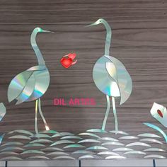 two flamingos standing next to each other on top of a wooden surface with the words dillartes