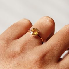 This ring with beautiful Natural Yellow sapphires, is set in 14 K Solid Gold. It is a ring perfect for any gifting occasion for your loved ones. Purchase the perfect gift for your mom, wife, daughter, girlfriend, and fiancee. This ring, due to its design, can also be stacked easily with other rings. -Material - 18K Solid Yellow Gold -Gemstone - Natural Yellow Sapphire -Gemstone weight - 2.190 ct -Gross weight - 2.4 grams Yellow Sapphire stone unites lovers who are separated. The wearer of yellow Yellow Gold Sapphire Ring With Faceted Detail, Gold Sapphire Rings With Faceted Detail, Yellow Sapphire Oval Promise Ring, Oval Yellow Sapphire Promise Ring, Minimalist Oval Sapphire Ring, Minimalist Citrine Gemstone Ring, Minimalist Citrine Birthstone Rings, Faceted Sapphire Promise Ring, Faceted Sapphire Ring Fine Jewelry