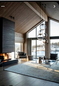 a living room filled with furniture and a fire place in front of a window covered in snow