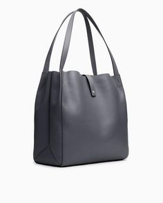 A highly versatile tote bag with contrasting straps, laptop compartment and pockets aplenty. 100% calf suede and leather trim. rag & bone Women's Large Tote Bag | Praline Suede Elegant On-the-go Satchel With Leather Trim, Modern Hobo Bag With Leather Trim For Shopping, Modern Shopping Hobo Bag With Leather Trim, Versatile Leather Shoulder Bag With Gunmetal Hardware, Leather Bucket Bag With Leather Trim, Leather Bucket Shoulder Bag With Leather Trim, Leather Bucket Bag With Shoulder Strap, On-the-go Leather Trim Satchel Bucket Bag, On-the-go Bucket Bag With Leather Trim