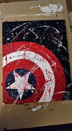 the captain's shield has been painted on and it is sitting in a cardboard box