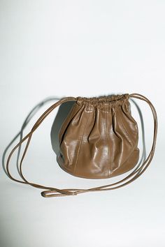 Paneled bucket bag with flat seamed details. Drawstring top that cinches shut and long slim crossbody straps. 6" diameter base, 8" tall with 20" strap drop. Unlined Italian leather. Craft Exhibition, Modern Weaving, Band Ideas, Accessory Inspo, Fall Bags, Accessories Bag, Leather Crafts, Drawstring Top, Unique Bags