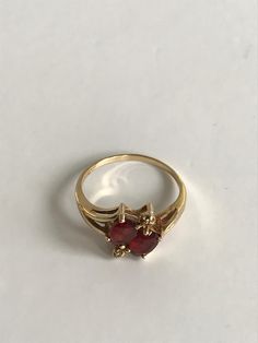 Ladies 14k Yellow Gold Vintage Two Stone Garnet Ring Ladies Size 7.5 * makes an excellent gift choice * unique ring- will not go unnoticedDisclaimer: All items in our store are vintage and pre-loved, which means they may show signs of gentle wear, including small dings, scratches, or other imperfections that add to their unique character. We do our best to describe and photograph each item accurately, but please feel free to reach out with any questions before purchasing. Thank you for appreciat Anniversary Red Cluster Ring Stamped 14k, Yellow Gold Ruby Ring For Valentine's Day, Valentine's Day Yellow Gold Ruby Ring, Classic Yellow Gold Heart Ring With Prong Setting, Fine Jewelry 14k Gold Ruby Ring For Formal Occasions, 14k Gold Ruby Ring Fine Jewelry For Formal Occasions, Yellow Gold Heart Cut Gemstone Ring, Yellow Gold Rings For Valentine's Day Formal Occasion, Formal 14k Gold Ruby Ring Fine Jewelry