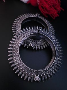 Steal everyone's attention with this stunning piece of jewellery.This kada/bracelet combines intricate detailing in a beautiful motif and contemporary design to help you make heads turn.The technique of oxidisation has been used to give a dull sheen and bring out the exquisite design.This is a bracelet that is openable and can be moulded to fit almost all sizes.Size :adjustable from 2 4 to 2.8 inches Traditional Oxidized Bangle For Wedding, Traditional Oxidized Wedding Bangle, Oxidized Finish Bangle For Festivals, Oxidized Finish Bangle For Wedding And Festivals, Bohemian Hand Set Metal Bracelets, Traditional Oxidized Bangle, Silver Temple Jewelry Bangle For Rituals, Antique Silver Bracelets With Oxidized Finish For Wedding, Festival Oxidized Bangle Jewelry