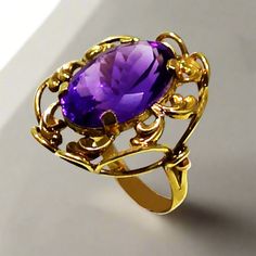 This exquisite ring is crafted from 14k gold and glistening with a deep purple amethyst. This timeless piece of jewelry will be a luxurious addition to your collection. Ring in Gold 14k Amethyst gemstone Classic Amethyst Ring Stamped 14k, Formal 14k Stamped Amethyst Ring, Elegant 14k Gold Amethyst Ring For Anniversary, Formal 14k Gold Amethyst Ring, Hallmarked 14k Gold Oval Amethyst Ring, Elegant Yellow Gold Amethyst Ring For Anniversary, Elegant Gold Amethyst Birthstone Ring, Elegant Purple Birthstone Ring For Formal Occasions, Elegant Formal Purple Birthstone Ring