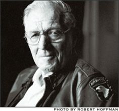 black and white photograph of an older man in leather jacket looking off to the side