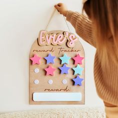 a wooden sign with stars hanging from it's side and the words erie's reward tracker