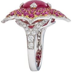 Imagine the feeling of pure luxury and elegance as you slip on the Pacha Ring in Ruby by Piranesi. With a stunning 3.71 carat cabochon ruby as the centerpiece, this ring exudes timeless beauty and sophistication. Surrounding the ruby are 2.91 carats of round rubies that complement the rich red color of the cabochon. To add a touch of sparkle and glamour, the ring is also adorned with 0.77 carats of round diamonds. The 18K white and rose gold setting enhances the natural beauty of the stones, cre Luxury Ruby Cabochon Diamond Ring, Luxury Ruby Ring With Cabochon Cut, Luxury Platinum Ruby Ring, Luxury Ruby Gemstone Ring In Platinum, Luxury Oval Cabochon Ruby Ring, Luxury White Gold Diamond Cabochons, Luxury Ruby Ring With Oval Cabochon, Fine Jewelry Cabochon Ruby Ring In White Gold, Fine Jewelry Ruby Cabochon Ring In White Gold