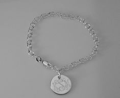 "This lovely sterling silver bracelet features a 17 gauge, high polish sterling silver 1/2\" diameter disc on a sterling silver 7\" chain, with a lobster claw clasp. I can engrave a monogram, one to three initials, or a name, date or word up to 10 characters. The back of the disc can also be engraved with up to 10 characters The bracelet will be delivered to you in a gift box. This style is also available in 8\" Length: https://www.etsy.com/listing/950524673/custom-engraved-monogram-or-initial? Classic Sterling Silver Charm Bracelet With Silver Chain, Sterling Silver Oval Link Charm Bracelet, Classic Engraved Sterling Silver Charm Bracelet, Silver Name Bracelet With Polished Finish As Gift, Silver Name Bracelet With Polished Finish, Hallmarked White Gold Chain Bracelet, Hallmarked White Gold Round Chain Bracelet, Classic Personalized Sterling Silver Charm Bracelet, Personalized Classic Sterling Silver Charm Bracelet