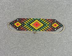 This beautiful beaded necklace is hand-woven by the women of the Embera Chami Indigenous Tribe of Colombia Traditional Rectangular Necklace For Festivals, Traditional Handwoven Festival Beads, Traditional Handwoven Choker As A Gift, Traditional Adjustable Rectangular Necklaces, Southwestern Handwoven Beads For Festival, Traditional Adjustable Handwoven Necklaces, Traditional Adjustable Rectangular Necklace, Traditional Weaving Jewelry As A Gift, Artisan Handwoven Rectangular Jewelry