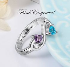 Personalized Mothers Infinity Ring 2 Heart Birthstones 2 Engraved Names This ring is made of .925 sterling silver. You can choose 2 engraved names and 2 birthstones. Enter like this, please- Birthstone 1- Name 1- Birthstone 2- Name 2- Inner engraving-  Names must be 10 characters or less and inner engraving 18 characters or less We hand-make this piece once the order is placed.  This takes 3-5 business days during the normal time of year but can take up to 10 business days if it is the holiday s Infinity Birthstone Ring For Anniversary, Engraved Silver Birthstone Ring For Anniversary, Silver Engraved Birthstone Ring For Anniversary, Personalized Silver Birthstone Ring For Anniversary, Personalized Heart Birthstone Ring In Sterling Silver, Personalized Silver Birthstone Ring For Valentine's Day, Infinity Silver Birthstone Ring Gift, Silver Infinity Birthstone Ring As Gift, Silver Infinity Birthstone Ring For Gift