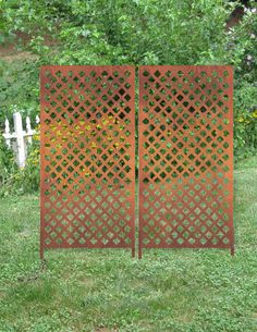 two metal gates sitting in the grass