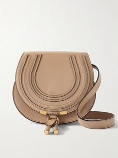 Chloé's 'Marcie' bag features so many of the label's hallmarks, from the saddle silhouette to the bohemian tassels. This mini version is made from textured-leather with just enough space inside for your wallet, cell phone and sunglasses, and has a tab-fastening front flap so you can access them easily. It’s finished with signature equestrian-style stitching and an embossed logo. Chloe Tassel Bag, Chloe Bag Leather, Chloe Marcie Medium, Chloe Crossbody Bag, Chloe Logo, Neutral Bag, Denim Flats, Floral Dresses Short, Chloe Bag