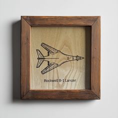 a wooden frame with a drawing of an airplane on it and the words rockwell b - 1 lance