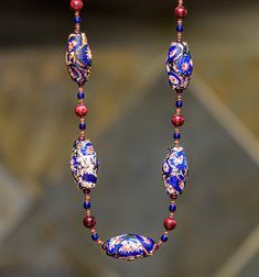 This necklace brings together centuries of trade beads history, from ancient excavated Indonesian "trade wind" beads, to antique African trade beads and the more recent Javanese beads of the early 20th century. The large (38-41mm), unusual deep blue bi-cone "end of the day" glass beads are the creation of Javanese bead makers of the early 20th century. They are decorated with fragments of older Venetian Chevron bead fragments. The larger 14mm blue round beads are antique Dogon glass beads from M Traditional Czech Glass Beaded Necklaces, Traditional Necklace With Polished Czech Glass Beads, Traditional Czech Glass Necklace With Polished Beads, Traditional Czech Glass Large Beads, Traditional Czech Glass Polished Beads, Traditional Single Strand Beaded Necklace, Traditional Single Strand Oval Beads, Artisan Beaded Necklace With Oval Spacer Beads, Traditional Jewelry With Czech Glass Round Beads