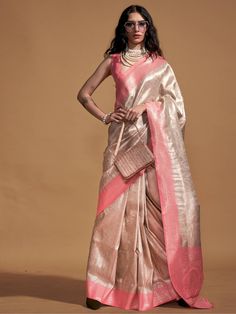 Flaunt your beauty and elegance in the upcoming festivals or marriages with this charming cream & peach saree. Crafted from high-quality silk material, this saree is the epitome of luxury and style. The zari weaving work adds a touch of tradition and grace to the saree, making it a perfect choice for any special occasion.
The saree comes with a similar color silk blouse that also features zari weaving work. This adds a coordinated and elegant look to the whole ensemble. The unstitched blouse Cinderella Fashion, Peach Color Saree, Bengali Culture, Formal Saree, Peach Saree, Handloom Weaving, Peach Art, Saree Style, Kanjivaram Silk Saree