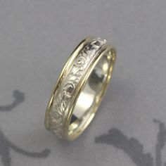 Band Antique Look Ring Gold and Silver Band Two Tone Ring Comfort Fit Band Patterned Ring Vintage Style Band Men's Wedding Ring Women's Band With just a touch of gold added to each side, our two tone Going Baroque band is a lovely compliment to a garden style wedding. Hand made from preformed sterling silver pattern wire featuring a stylized vine and leaf pattern, a 1mm diameter strip of full round solid 14K gold is added to each edge. This gives the band a nice comfort fit edge and also contras Ring Gold And Silver, Two Tone Ring, Ringe Gold, Pattern Ring, Men's Wedding Ring, Ring Vintage, Ring Gold, Wedding Rings For Women, Silver Band