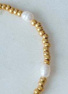 Elevate your arm candy with our Boardwalk beaded pearl bracelet! Made with dainty gold beads and tiny rice pearls, this bracelet will make you feel like you're strolling down the boardwalk. Add a touch of coastal charm to any look with this must-have accessory. Please refer to the bracelet size chart for your bracelet size. Everyday 14k Gold Filled Bracelets With Pearl Charm, Pearl Bracelet With Tiny Round Beads, Dainty Pearl Beaded Bracelets With Pearl Drop, Dainty Stackable Pearl Bracelet With Round Beads, Everyday 14k Gold Filled Beaded Bracelets With Pearl Charm, Adjustable Beaded Bracelets With Pearl Charm For Everyday, Everyday Pearl Beaded Bracelets With Pearl Chain, Everyday Beaded Bracelets With Pearl Drop, Dainty Adjustable Beaded Bracelets With Pearl Chain