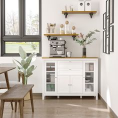 a kitchen with white walls and wooden flooring next to a window filled with potted plants