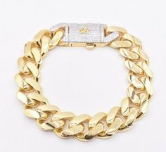 "15mm Miami Cuban Royal Link Bracelet Plain CZ Box Clasp Real 10K Yellow Gold * Metal : Real 10K Yellow Gold (Properly Stamped, 10K or 417) * Condition : Brand New * Finish : Polished * Avg Weight : 23.00 grams (8.5\" version) 2.70 grams/per inch * Length : Selectable * Width : 5/8\" = 15mm * Clasp/Bail : Double Safety Lock All of our items are brand new and are shipped with a gift box." Yellow Gold Cuban Link Diamond Bracelet Gift, Formal Cuban Link Bracelet With Diamond Accents In Gold, Gift Cuban Link Diamond Bracelet With 17 Jewels, Silver 14k Gold Cuban Link Bracelet As Gift, Silver-toned 14k Gold Cuban Link Bracelet As Gift, Gold Diamond Cut Cuban Link Bracelet, Cuban Link Bracelet With Polished Finish As Gift, Gold Cuban Link Bracelets With Diamond Accents, Yellow Gold Diamond Cut Cuban Link Bracelet Gift