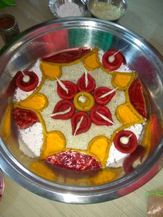 a metal bowl filled with food on top of a table