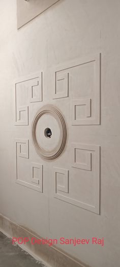 a white wall with a round hole in the middle