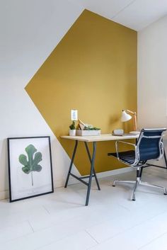 a room with a desk, chair and pictures on the wall next to each other