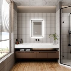 a bathroom with a sink, mirror and shower stall in it's center area