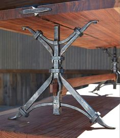 a wooden table topped with metal brackets on top of it