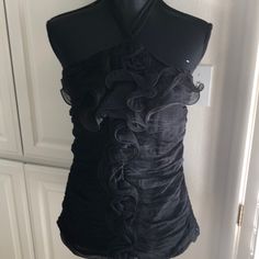 Ruffled Black Wrap Around Neck Blouse With Stretchy Back. Elegant Stretch Top With Ruffles, Elegant Stretch Tops With Ruffles, Elegant Ruffled Stretch Top, Ruched Formal Tops For Summer, Summer Formal Ruched Tops, Formal Ruched Tops For Summer, Black Ruched Evening Blouse, Flirty Ruffled Blouse For Night Out, Stretch Ruffled Tops For Night Out