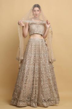 Festive earthy beige lehenga with an attached cancan and mirror and thread embroidery. Comes with a padded blouse and a dupatta. - Aza Fashions Beige Gown With Zari Work, Beige Choli With Sheer Dupatta, Beige Bollywood Dress For Reception, Beige Semi-stitched Dress For Reception, Beige Wedding Gown With Sheer Dupatta, Traditional Beige Lehenga With Intricate Embroidery, Traditional Drape Lehenga With Intricate Embroidery, Beige Anarkali Gown With Sheer Dupatta, Beige Lehenga With Intricate Embroidery