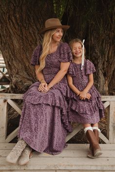 Looking for a modest girl's dress for your next big event? Allow us to introduce you to our Mini Solana Dress! Made from a vibrant purple lace burnout fabric, this dress features a square neckline and short flutter sleeves. The midi-length ruffle tiered skirt adds a touch of playfulness and includes functional pockets, while the hidden back zipper and front corset create a perfect, stylish fit. Country Chic Dresses, Modest Girls Dresses, Modest Girl, Burnout Fabric, Country Dresses, Vibrant Purple, Purple Lace, Dress Purple, Tier Skirt