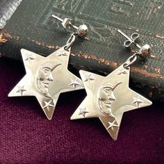 VINTAGE COSTUME JEWELRY EARRINGS -Dangly Stars With Crescent Moons -Silver Tone Metal -Pierced Ears This listing is for a pair of vintage (1990s) silver tone metal earrings with a celestial theme. They feature dangling star charms with crescent moon faces in the center. These are for pierced ears. These earrings are very light weight and easy to wear! Ready to be loved, treasured and worn. They also present beautifully as a gift for someone who loves celestial themed jewelry. These are vintage o Star Earrings Dangle, Metal Gifts, Crescent Moon Jewelry, Celestial Earrings, Antique Locket, Crescent Moon Earrings, Vintage Belt Buckles, Costume Jewelry Earrings, Moon Jewelry