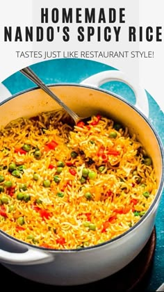 a pot filled with rice and peas on top of a blue table next to a white plate