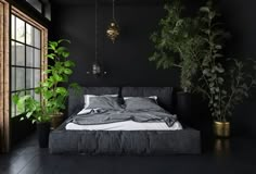 a bedroom with black walls and plants in the corner