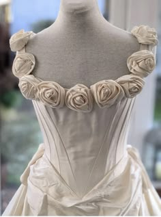 a white wedding dress with roses on it