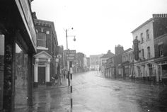 an old black and white photo of a city street