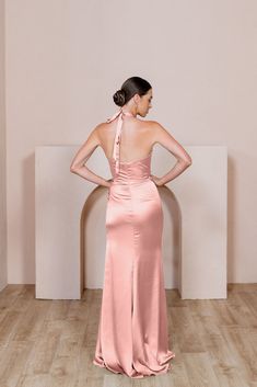 Enhance your bridal party with this modern and fitted version of a halter dress that will keep everyone looking! Our Fallon Satin dress features a halter neck that ties in the back with thick satin straps leaving your back open and is then finished with a delicate gathering at the waist on the left side of this dress to provide extra tummy coverage. Fallon pairs well with our Rory, Jade, and Dawson dresses. FEATURES: Fitted silhouette Halter top neckline Built-in bra cups and vertical boning for Revelry Bridesmaid Dresses, Revelry Bridesmaid, Satin Halter Dress, Wedding Parties Colors, Top Neckline, Dress Bridesmaids, Bridesmaid Dress Colors, Halterneck Dress, Fitted Silhouette